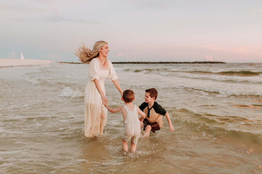mother with sons playing on the beach