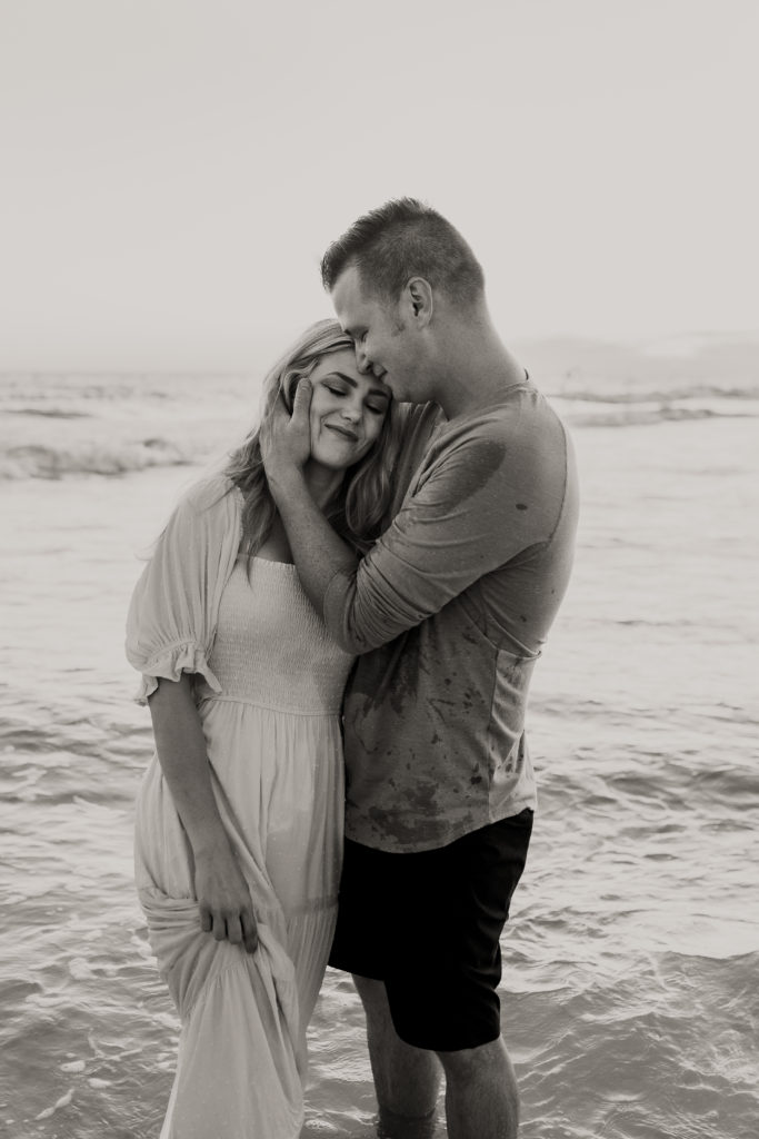a couple embracing on panama city beach during a photo session